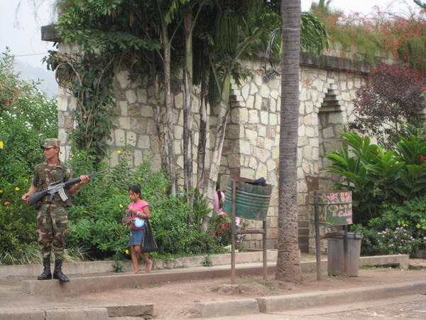Soldier and trinket seller in front of main plaza