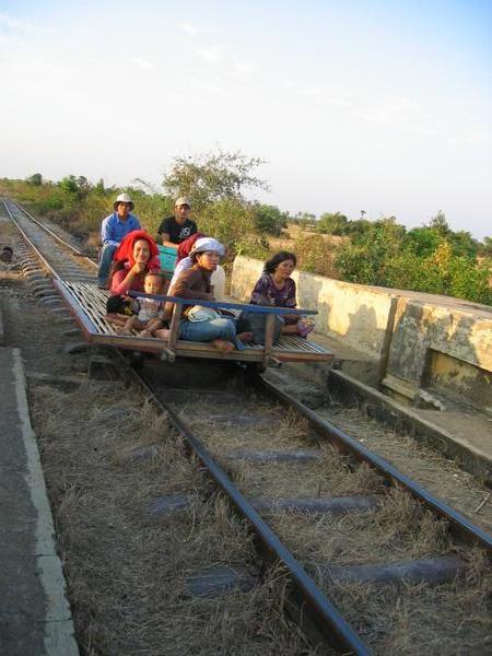 Locals riding the bamboo train