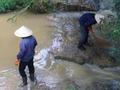Vietnamese workers cleaning up the river