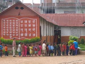 Nepali kids lined up in front of a classroom
