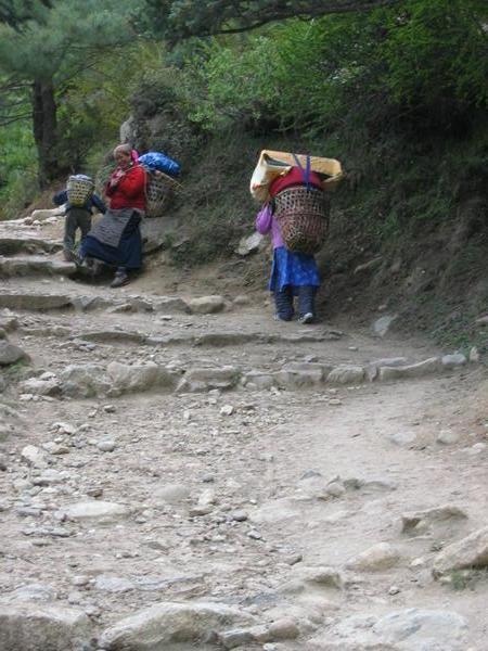 Porters walking up the stone steps