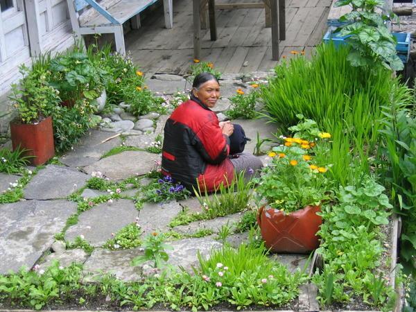 Woman tending her garden in Benkar