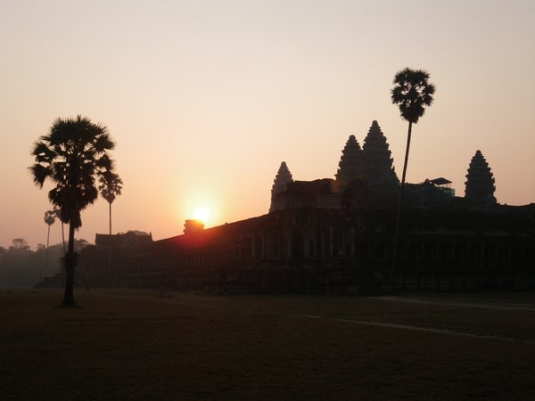 The sun behind the temple