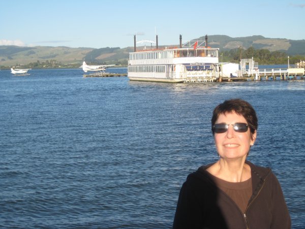 Judy at Rotorua Lake with paddle boat in the background
