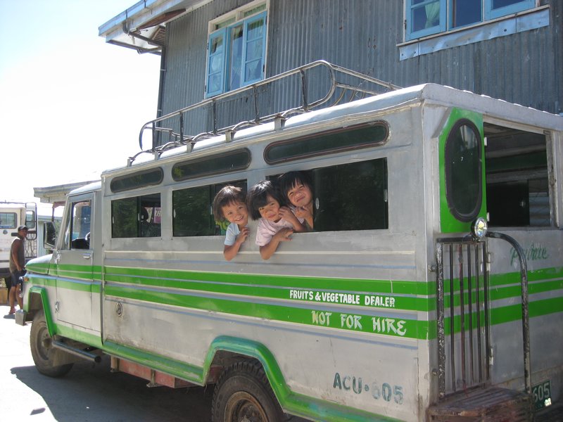 Kids playing in a jeepney