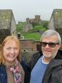 Us on castle roof with Saxon church and Roman lighthouse in background 