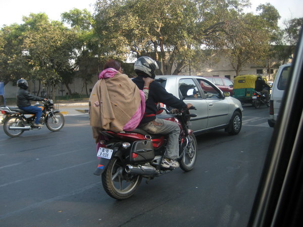 Woman in sari riding a skooter 
