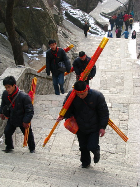 Pilgrims carrying huge sticks of incense