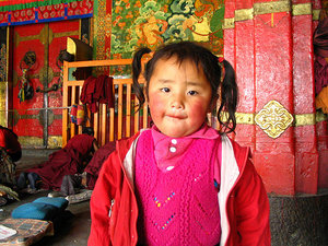 Child and Pilgrims in front of Jokhang, Lhasa, Tibet