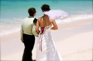 New married couple strolls the beach