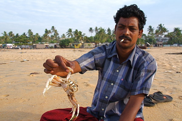 Showing off his crabs, Kollam Beach, Kerala
