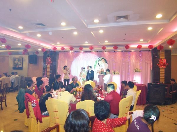 Bride and groom are introduced on stage.