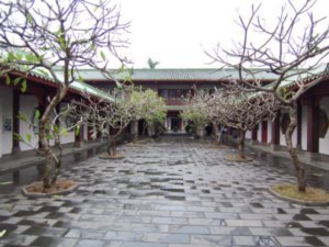 Fragrant Franjipanee-trees line the entrance toward the temple.