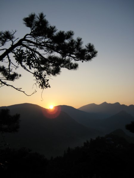 The sun begins to offer its warmth of the day, as it raises over Lu Shan Mountain.