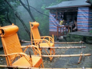 CHAIRS ARE WAITING FOR VISITORS, WHO HAVE LOST STEAM TRAVERSING THE THOUSANDS OF STEPS THROUGH-OUT LU SHAN MOUNTAIN.