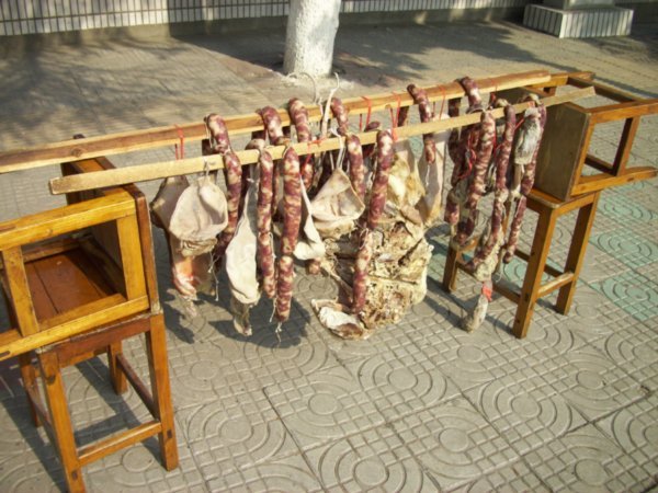 Home made sausages and pork pieces hang to cure.