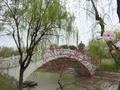 A marble moon bridge leads into the gardens of Mei LanFang.
