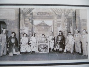 Photo Copy of PuYi on the throne of China as a child, surrounded by ministers and guards.