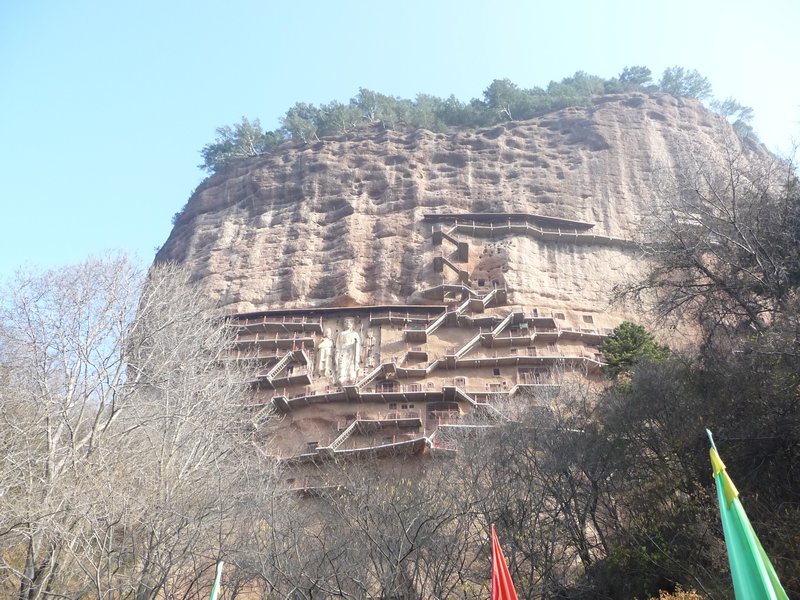 Maiji Shan/Mountain rises more than 500 feet into the blue sky.