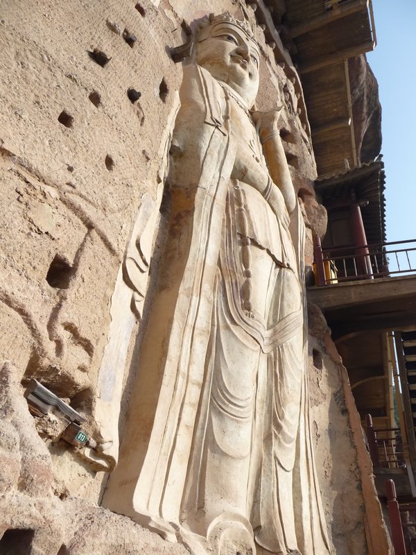 The holes around the statues were probably used to support a protective framework.