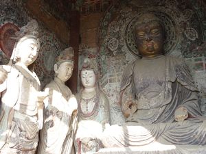The Buddhas in these pavilions are seated with the legs crossed on a lotus seat, flanked by the disciples.