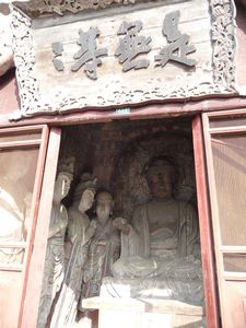 Each grottoe contains a Buddha, surrounded by Bodhisattvas and disciples.