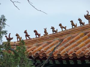 Close-up of the 9 mythical animals on the roof of the temple of Confucius in Qufu.