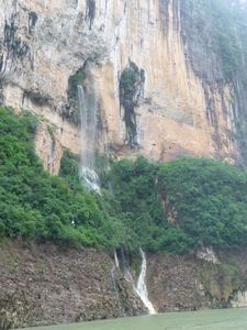 There must be great rivers flowing through caves inside of these cliffs. The spew their content into the Shennong Stream below.