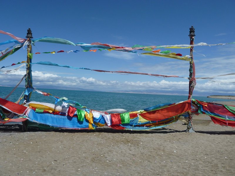 Tibetan-prayer flags send their messages into the winds along the shores of Qinghai Lake.