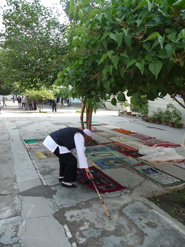 Within the courtyard of the Great Mosque, this man begins to reserve is space for the Friday prayers.