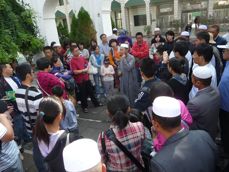An Iman gives informative tours to visitors of the Great Mosque in Xining.