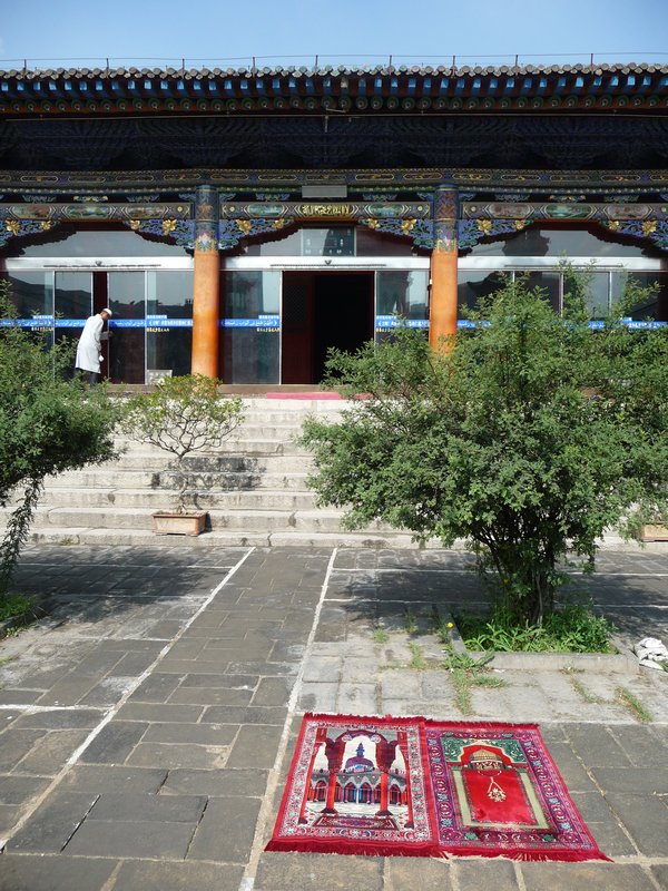 Prayer-rugs are spotted all over the courtyard, these two facing the great prayer hall.