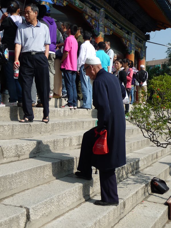 The crowds of tourists make it hard for this man to enter the great prayer hall.