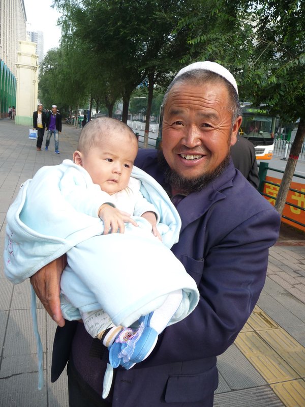 As this proud Grandfather shows off his beautiful grandchild to me near the Grand Mosque of Xining, it is time to close this photo essay and say good bye for now.
