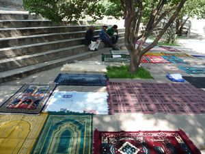 The shady spaces of the courtyard of the Great Mosque are quickly reserved by prayer rugs.