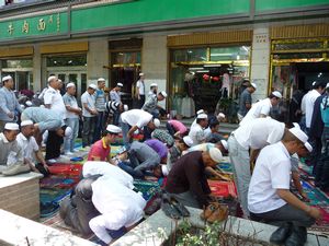 Friday prayers have begun, even on the side-walks of Xining surrounding the Great Mosque.