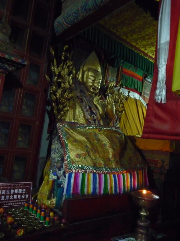 Golden statue  of Tsong Khapa, founder of the Yellow Hat Buddhist sect, is displayed within the center of the Great Hall of the Golden Roof, the most important shrine of the Ta'er Si Monastery.