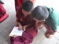 This young monk is perfecting his skills with the Tibetan alphabet.