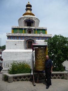 Along the first narrow path, I admire this sacrificial Stupa and prayer-wheel.