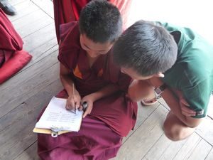 This young monk is perfecting his skills with the Tibetan alphabet.