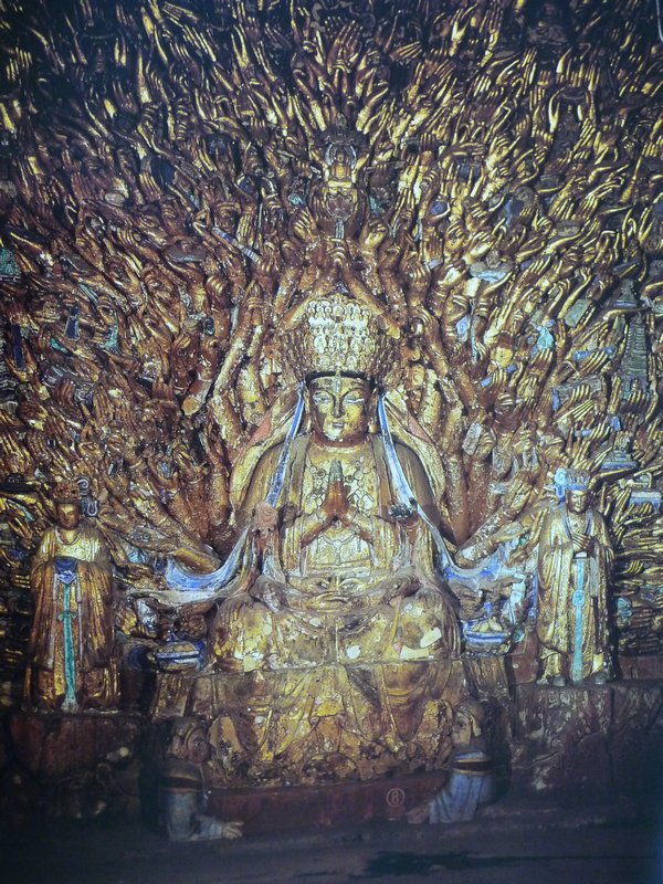 The 1,000-armed Guanyin has in fact 1,007 gilded arms that seem to flicker like flames from the central figure of Guanyin, and each palm holds a different symbol of the bodhisattva.