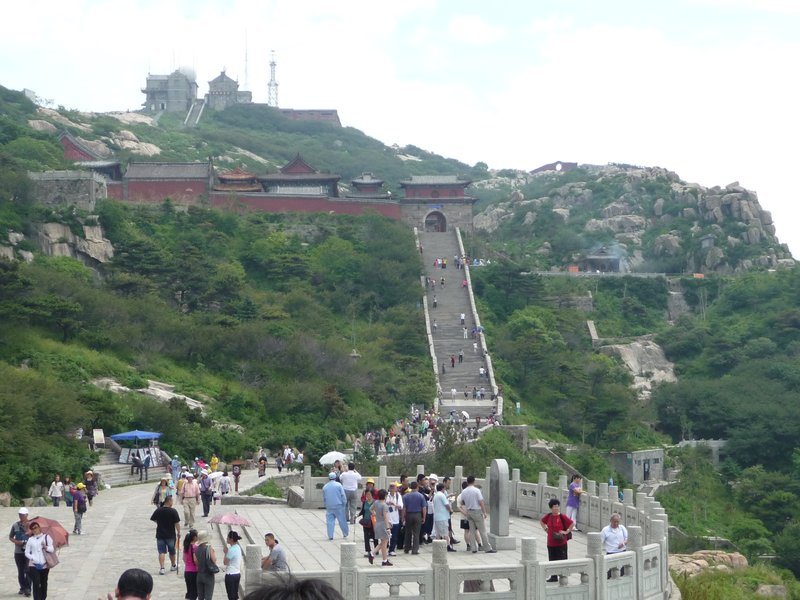 The stairs continue, guiding pilgrims and visitors toward more temple compounds.