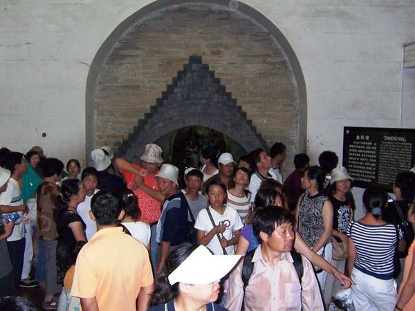 Visitors dwarf, walking the corridors of the tomb.