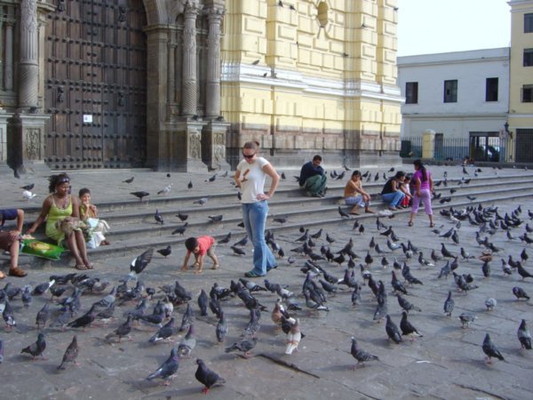 The one in jeans is me, the little things on the ground are an exotic Peruvian bird species called Pidgeon