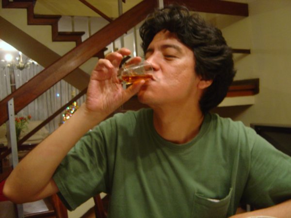 Javier trying a very interesting drink from his father