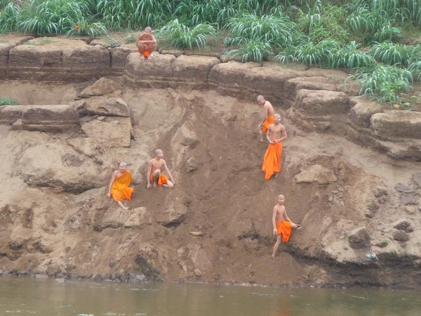 Monks playing around the river