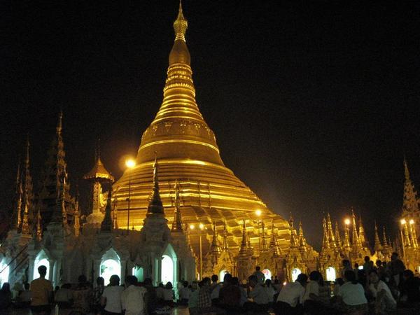 Devotees kneel around the Shwedagon, (Yangon)