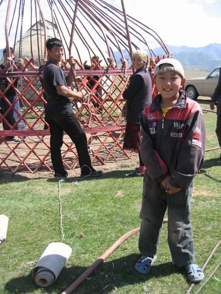 Aibek poses proudly in front of the rapidly-assembling yurt