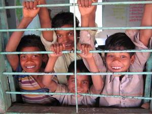 School-kids come to the window to say goodbye after I paid a short visit to their classroom