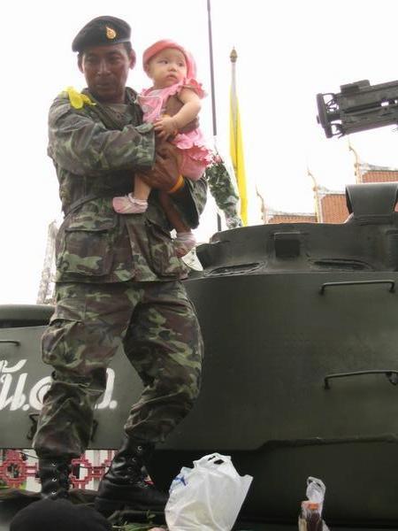 Admirably patient soldier poses with his fifth baby in as many minutes